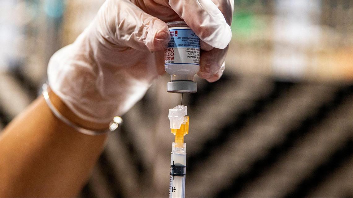 A nurse for Miami Jewish Health, a long-term care facility, prepares a dose of the Moderna vaccine for COVID-19 to administer to an employee on August 19, 2021.