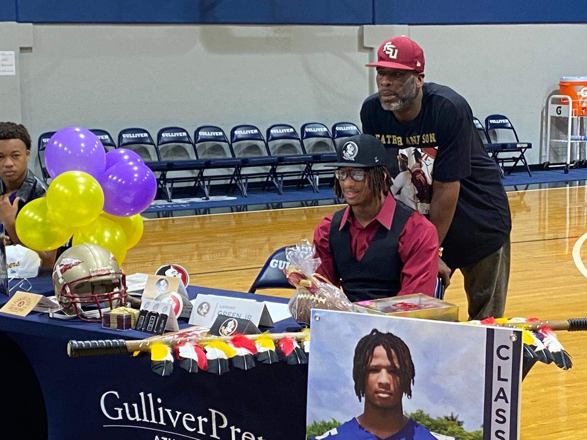 Gulliver Prep defensive end Lamont Green Jr. poses with his father, FSU great Lamont, Sr., before signing his letter of intent with the Seminoles on Wednesday at a ceremony at Gulliver.