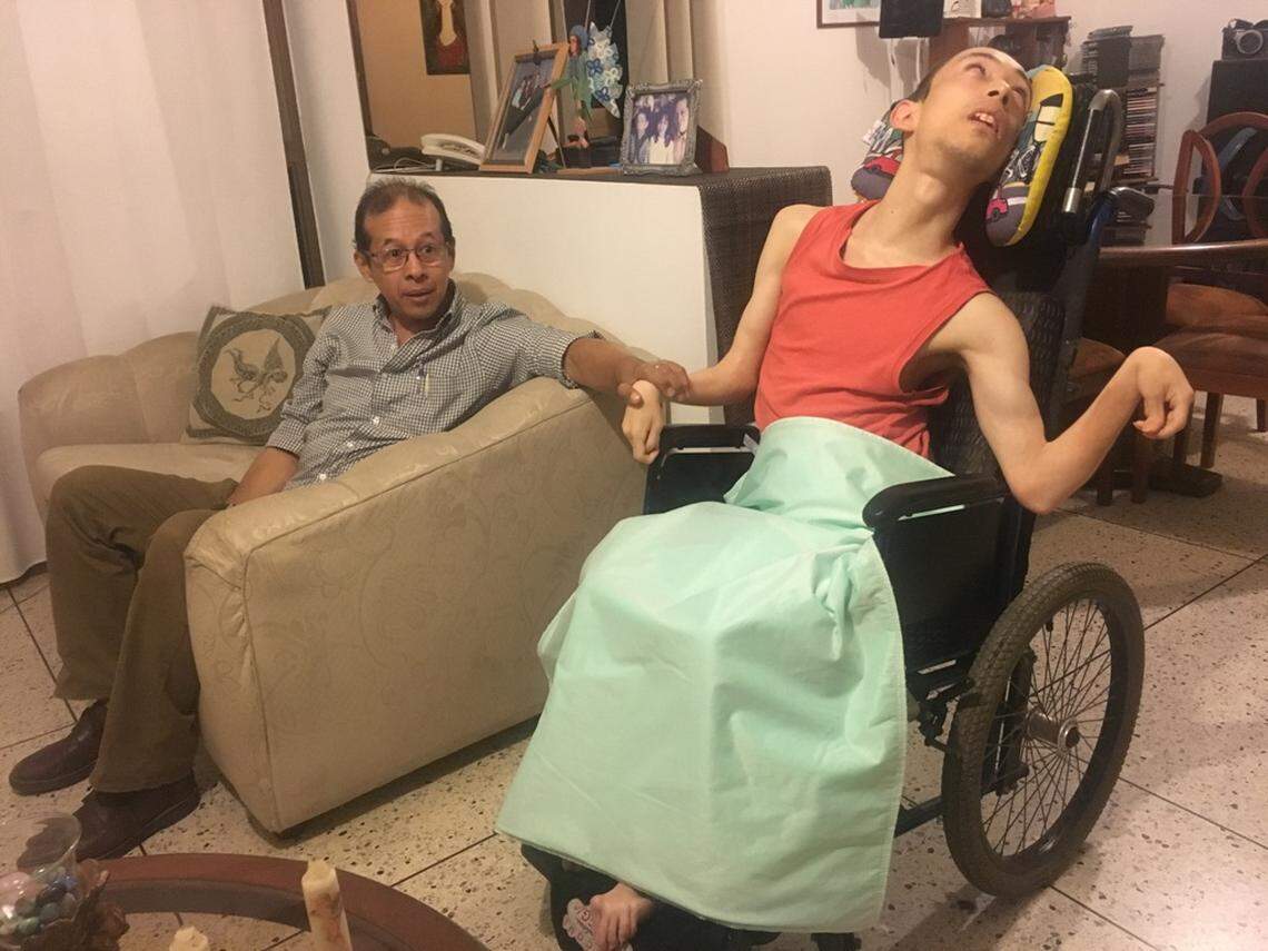 Marcos José Molero Sr., left, and his 27-year-old son Marcos, who is a quadriplegic, say they suffer in the dark and heat during frequent power outages in the city of Maracaibo, Venezuela.