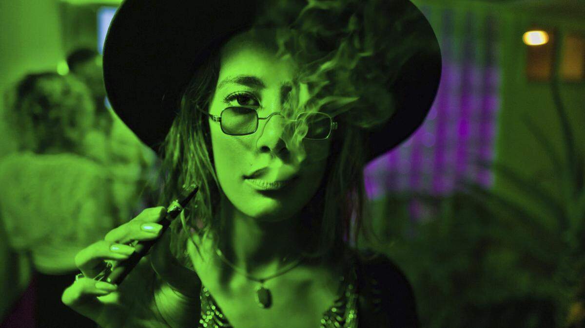In this Saturday, July 21,2018 photo Talia Serene smokes a CBD vape pen during a birthday party for one of the cofounders of the Lit.Club specializing in CBD Vape Pens and pre-rolled joints in the Bel-Air neighborhood of Los Angeles.