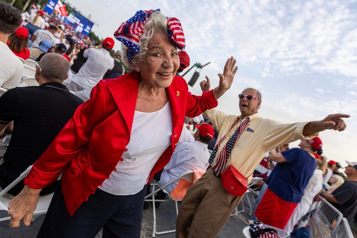 Trump supporters dance while waiting for former President Donald Trump to speak at a rally at Trump National on Tuesday, July 9, 2024, in Doral, Fla.