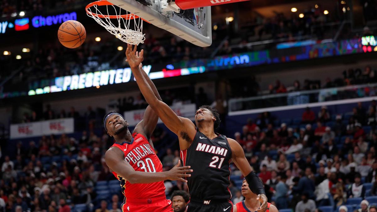 Heat center Hassan Whiteside battles for a rebound with Pelicans forward Julius Randle during Sunday’s game in New Orleans. Whiteside finished with 17 points, 12 rebounds and three blocks in Miami’s win.