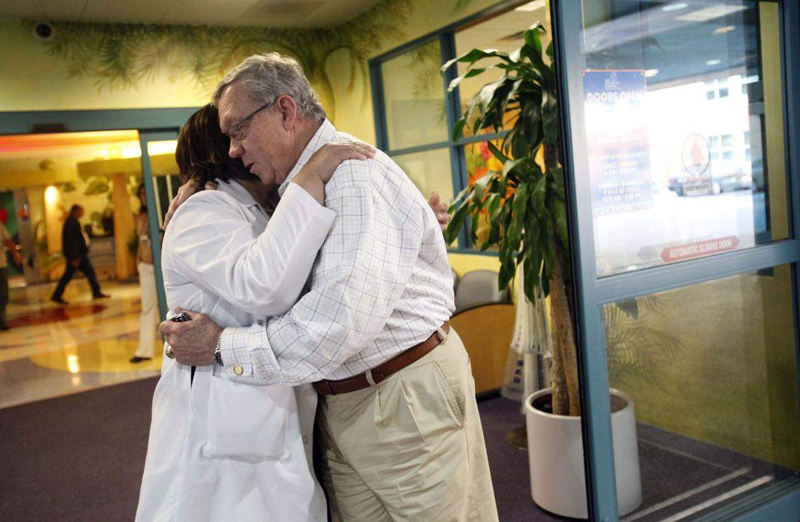 George Sheldon shares an emotional hug with Miami Children’s Hospital Chief Medical Officer Dr. Deise Granado-Villar after visiting with several Haitian youngsters recovering from injuries sustained in the earthquake that devastated their country.