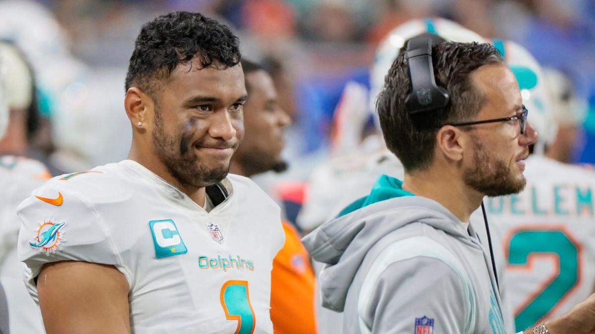 Miami Dolphins quarterback Tua Tagovailoa (1) and Miami Dolphins head coach Mike McDaniel on the sidelines as the Dolphins lead against the Detroit Lions in the fourth quarter at Ford Field in Detroit, Michigan on Sunday, October 30, 2022.