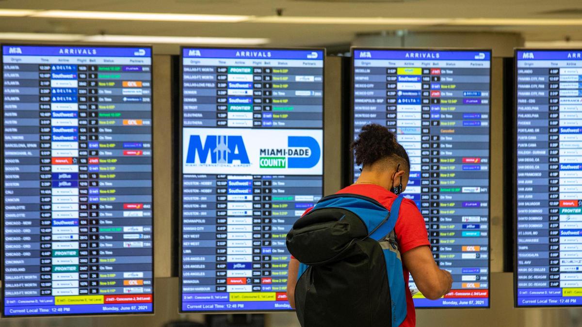 A traveler checks the time of his connecting flight in the arrival terminals at Miami International Airport in Miami, Florida, on Monday, June 7, 2021.