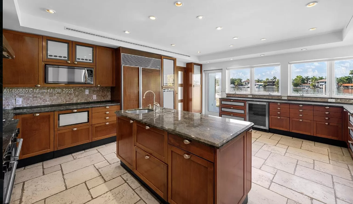 Marketed as a prime site for redevelopment, the Hibiscus Island residence has gone through many chapters. It was first built in 1930. The original entrance of the home is left standing, but the house has been added to throughout the decades with most recently in 2006. Above: Inside the home’s kitchen.