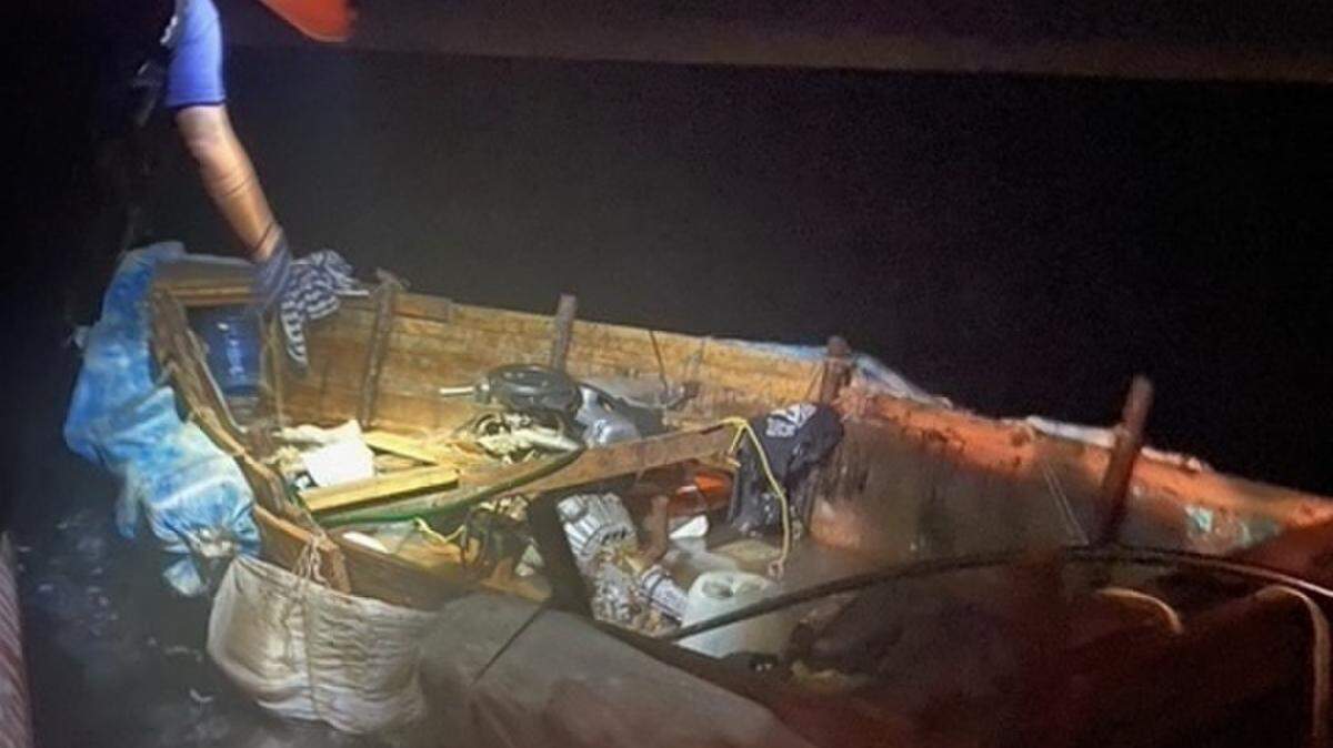Coast Guard crews check out a small, makeshift boat found off Key Largo Thursday, April 1, 2021, on which were 11 people from Cuba.