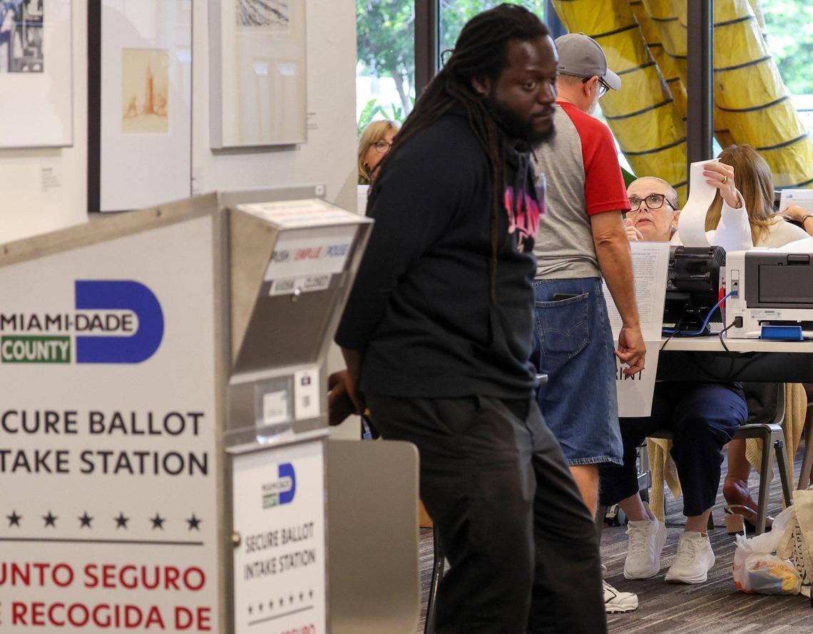Poll workers assist voters as they arrived at the Coral Gables Library to cast their vote during early voting on Monday, Oct. 21, 2024, in Coral Gables, Florida.