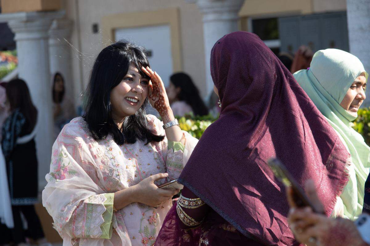 Two women greet each other in front of the Masjid An-Noor mosque in West Kendall on Eid-ul-Fitr, Monday, May 2, 2022, marking the end of Ramadan, the Islamic holy month of fasting and prayer. It was the first time since the pandemic began that services were held in person.