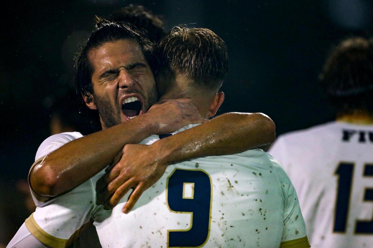 FIU Panthers midfielder Matteo Gasperoni (8) celebrates by hugging goal scorer forward Rasmus Tobinski (9) during the first half of an NCAA soccer tournament game against New Hampshire at FIU Soccer Stadium at Florida International University in Miami, Florida, Sunday, November 20, 2022.