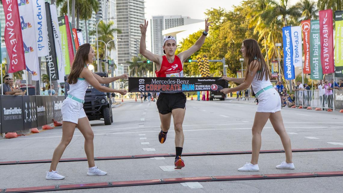 Dan Nestor, 25, from INTRADECO crosses the finish line first during the Mercedes-Benz Miami Corporate Run at Bayfront Park in Miami, Florida, on Thursday, April 25, 2019.