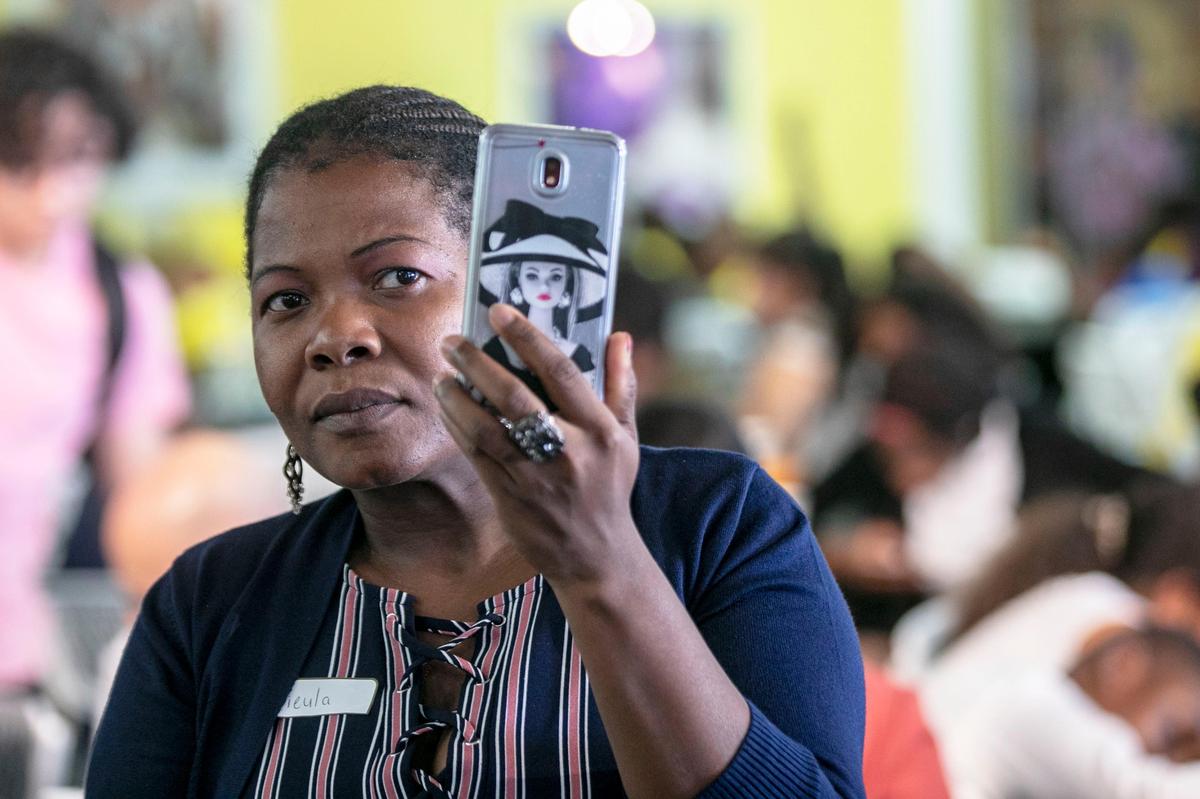 Miami local and TPS recipient Dieula Forestal records video during the TPS, DACA, DED recipients Press Conference at the Caribbean Marketplace in Little Haiti on Friday, June 14, 2019. The Trump administration has ended TPS for six countries, including El Salvador, Haiti, Honduras, Nepal, Nicaragua, and Sudan.