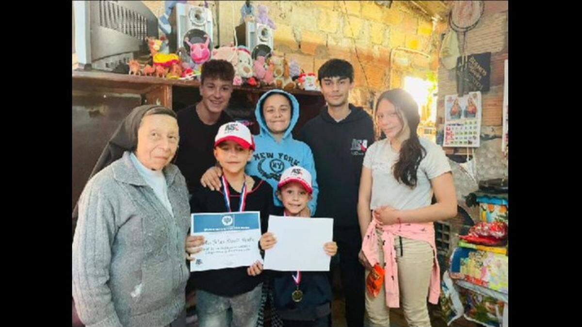Joshua Strauss, back left, and Adrian E. Sanchez helped Cindy Dimate and her three children, Nichole, Justin and Juan, and other families in Bogota, Colombia. Also pictured is Sister Ligia Neira, director of the Colombian Foundation of Community Services.