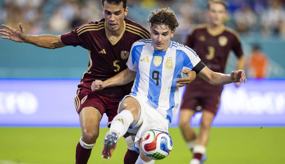 Argentina forward Julian Alvarez (9) and Venezuela defender Teo Quintero (5) compete for the ball in the first half of their friendly soccer match at Hard Rock Stadium on Friday, Oct. 10, 2025, in Miami Gardens, Fla.