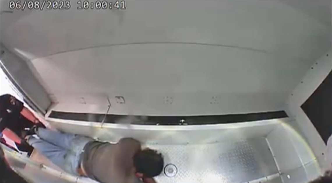 Sanchez-Mayen inside the police van.