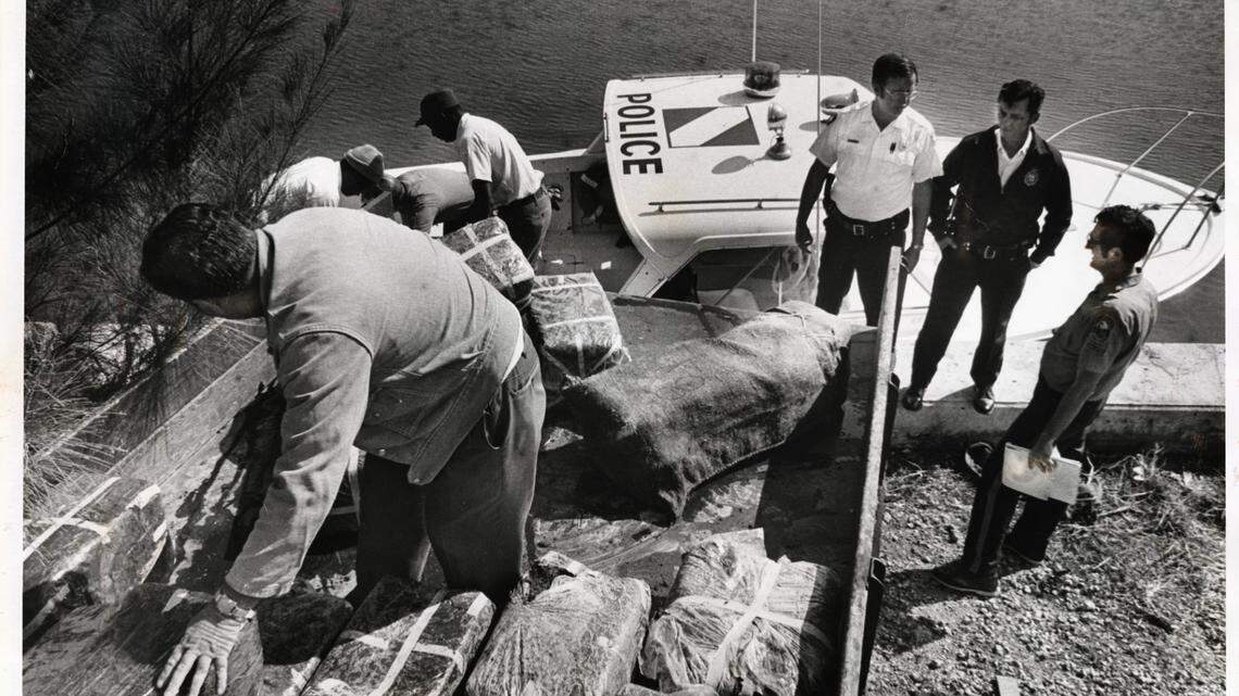 File photo from Jan.1, 1976, of marijuana being loaded into truck from a Dade County Marine Patrol boat after picking up bundles floating in Biscayne Bay. Coral Gables police and workers assist at sea wall in Coral Gables by the Sea location.