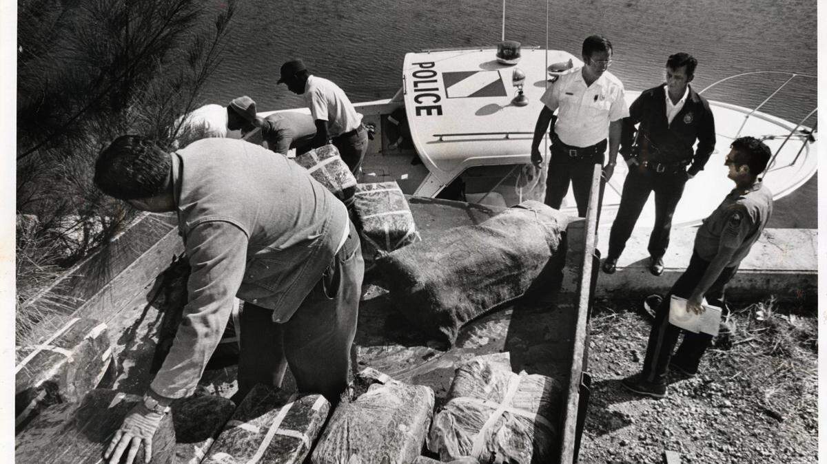 File photo from Jan.1, 1976, of marijuana being loaded into truck from a Dade County Marine Patrol boat after picking up bundles floating in Biscayne Bay. Coral Gables police and workers assist at sea wall in Coral Gables by the Sea location.