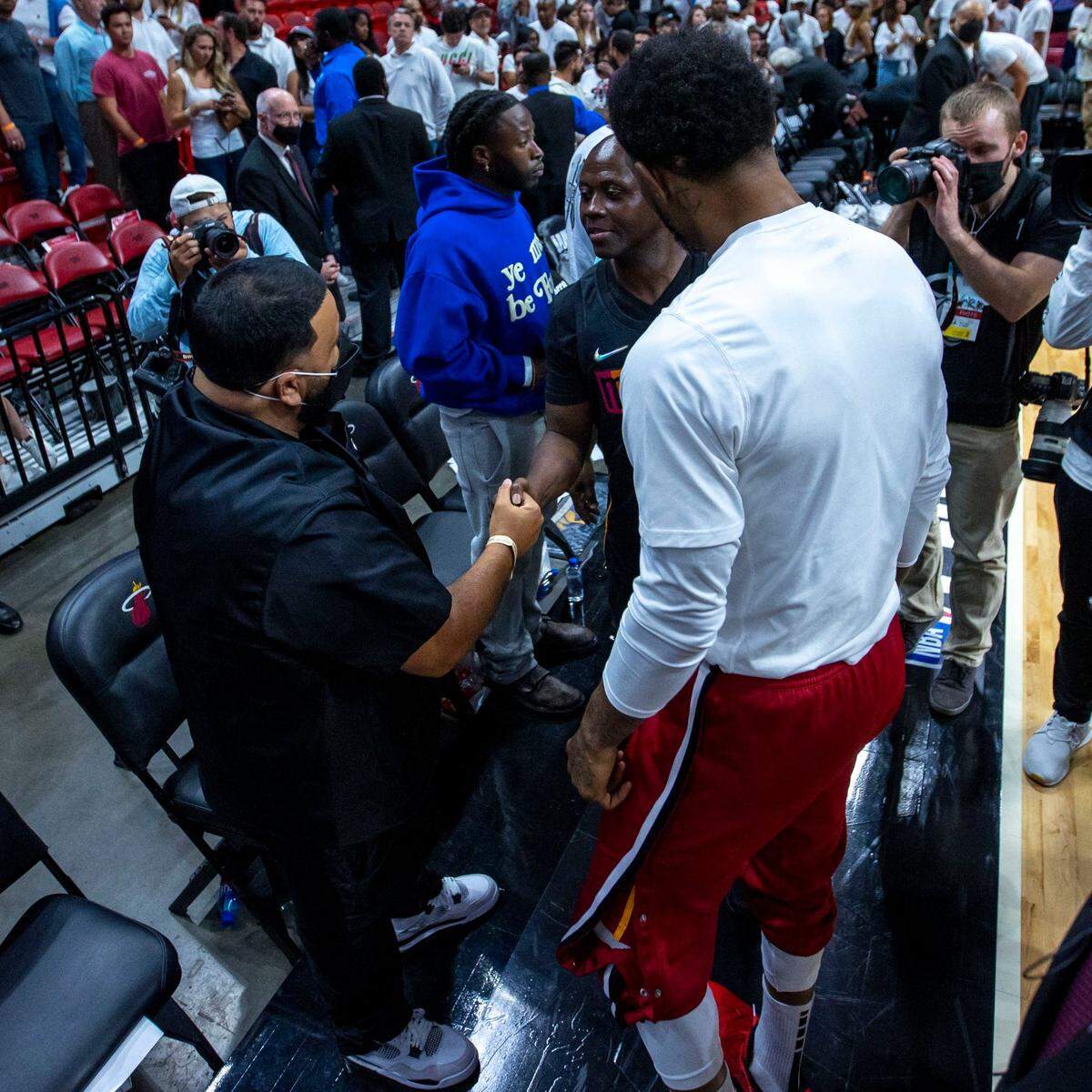 Miami Heat forward Udonis Haslem introduces DJ Khaled, left, to Thomas Raynard James, who was falsely convicted of first-degree murder on Jan. 11, 1991, and sentenced to life behind bars, after Game 1 of a second round NBA Eastern Conference semifinal playoff series against the Philadelphia 76ers at FTX Arena in Miami, Florida, on Monday, May 2, 2022.