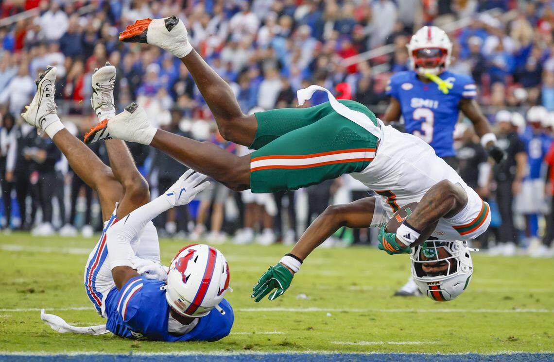 Miami Hurricanes wide receiver Joshisa Trader (1) scores on a pass reception as Southern Methodist University Mustangs cornerback Marcellus Barnes Jr. (8) fails to defend in the first half of an NCAA football game at Gerald Ford Stadium on Saturday, November 1, 2025, in Dallas, Texas.