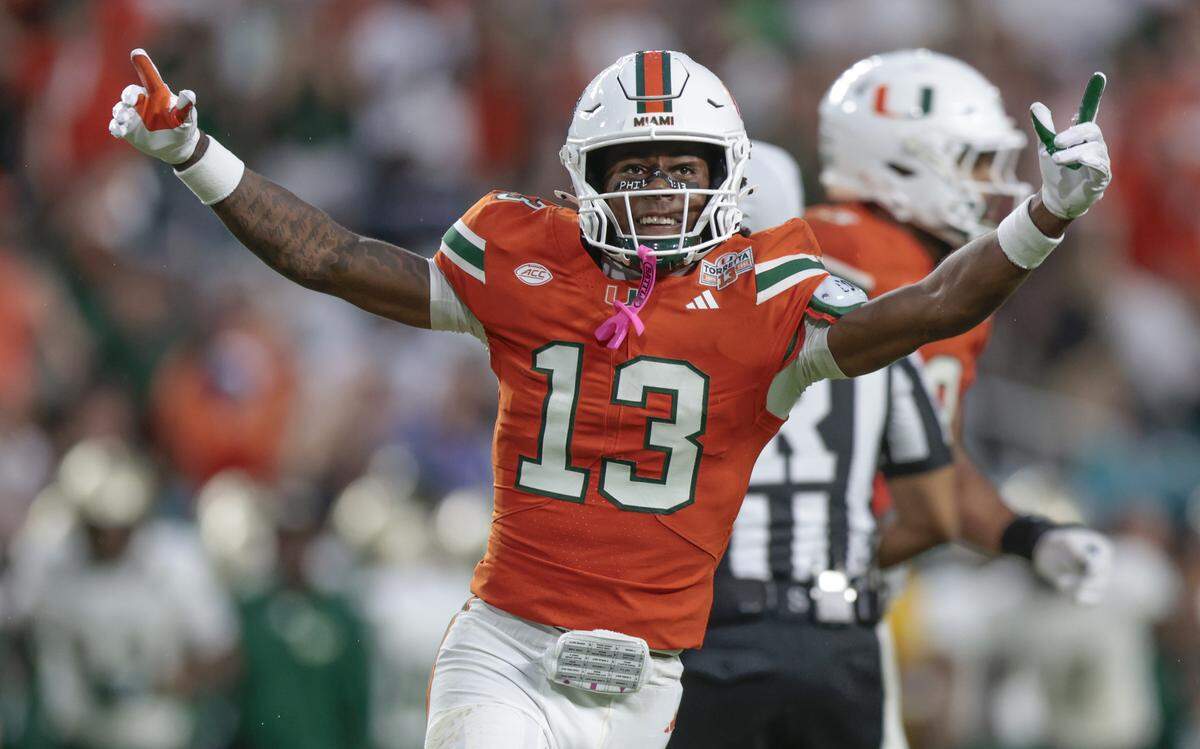 Miami Hurricanes defensive back Bryce Fitzgerald (13) reacts after an interception against the South Florida Bulls during their NCAA football game at Hard Rock Stadium in Miami Gardens, Florida, on Saturday, September 13, 2025.