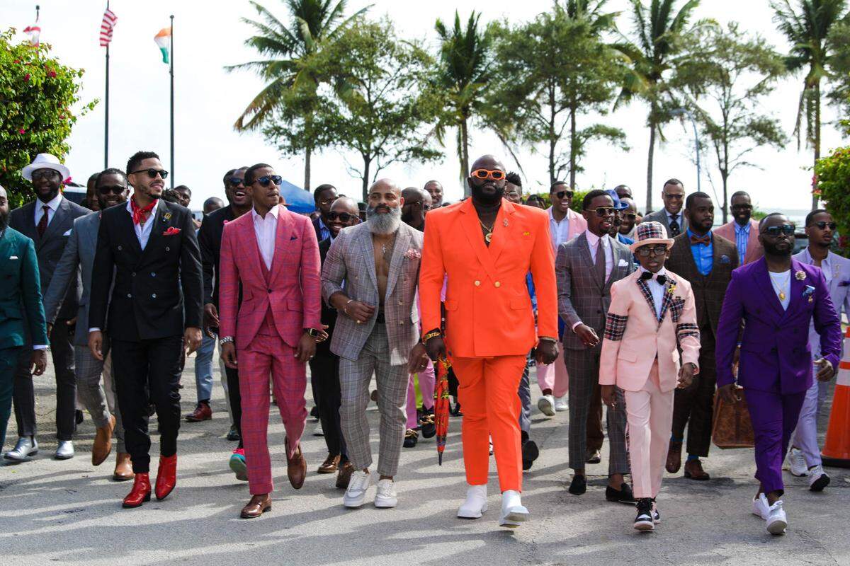 NeAndre Broussard (second from left) walks among participants of the 2021 Black Menswear FlashMob in Miami, FL on Dec. 18, 2021. The FlashMob series has taken place in various cities across the globe including Los Angeles, Toronto and Accra.
