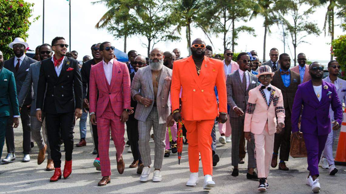 NeAndre Broussard, second from left, walks among participants of the 2021 Black Menswear FlashMob in Miami on Dec. 18, 2021. The FlashMob series has taken place in various cities across the globe including Los Angeles, Toronto and Accra.