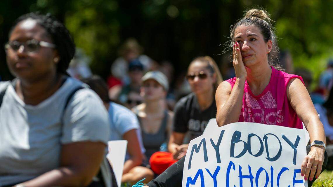 Maria Laura Alfonsin wipes a tear at the Bans Off Our Bodies rally at in Miami, Florida on May 14, 2022.