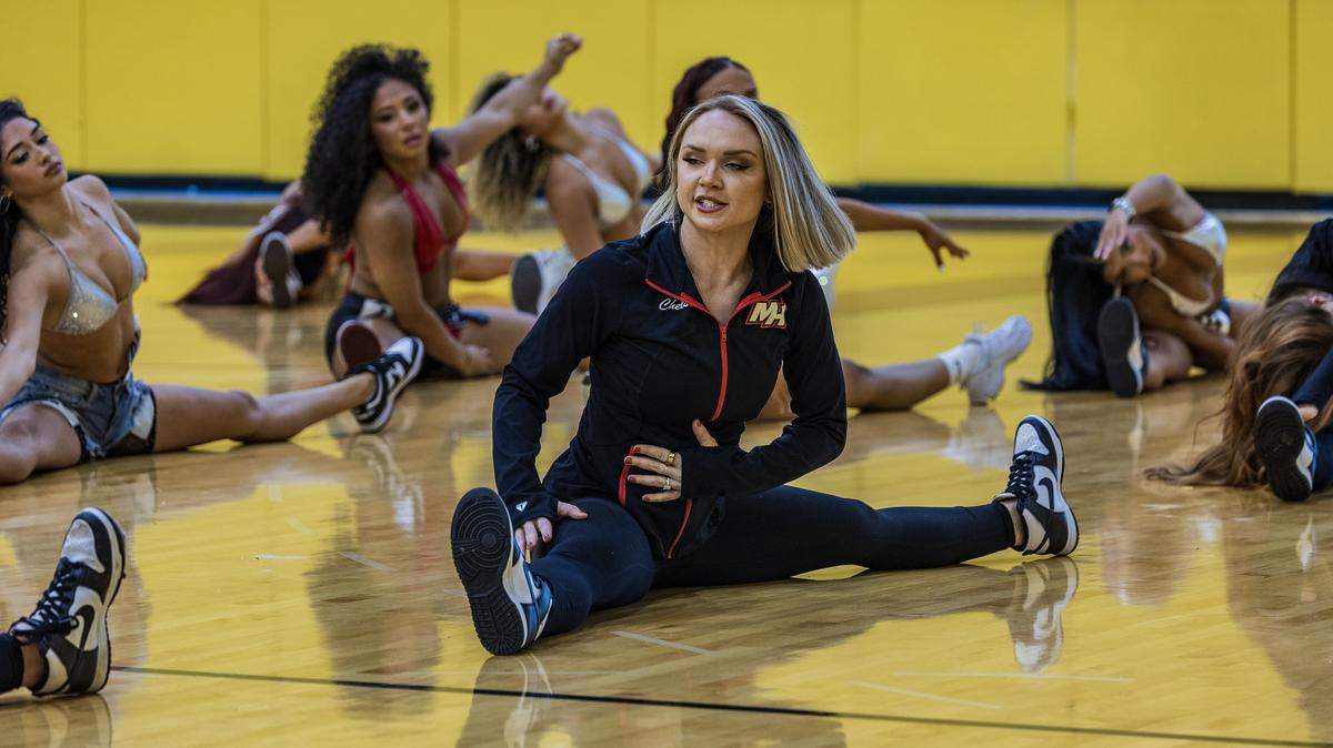 Chelsea Varsaci, a lawyer and Miami Heat dancer, leads a warm-up during an audition workshop at the Kaseya Center in Miami on Thursday July 24, 2025.