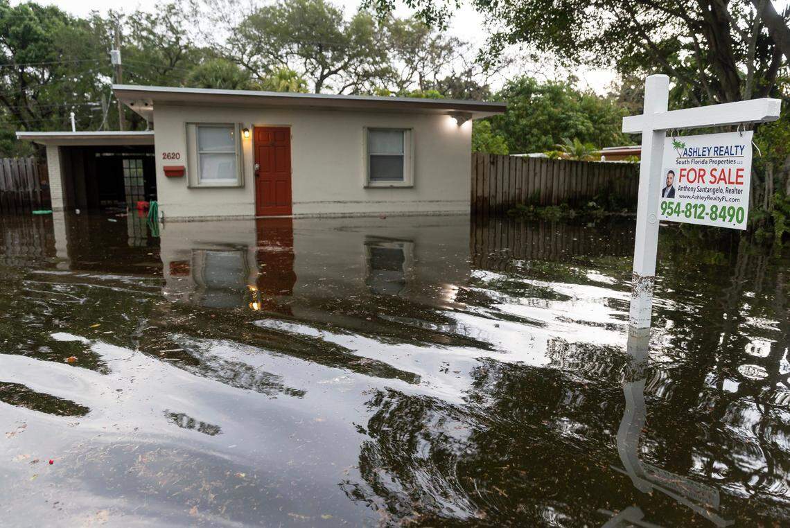 A Fort Lauderdale home for sale is seen partially submerged in the Edgewood neighborhood after the 2023 rainbomb. As climate change makes intense rainfall, tidal flooding and higher storm surge more common, experts say it still hasn’t fully factored into Florida’s real estate market.