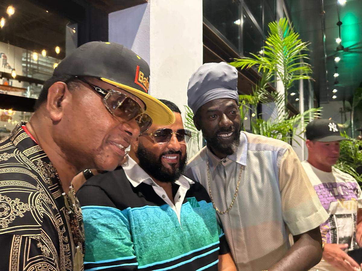 Buju Banton (right), here with DJ Khaled (center) take pictures with a fan during a launch for Best of the Best music festival.