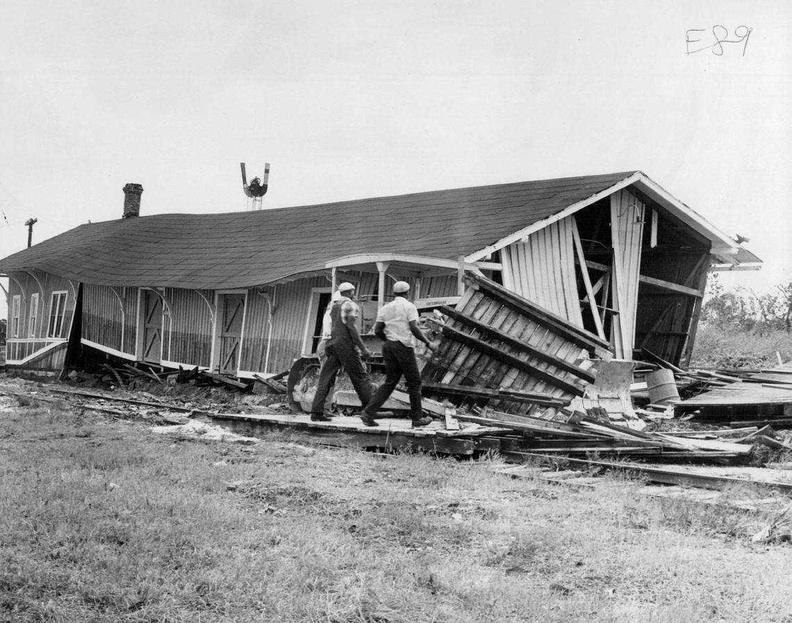 The abandoned Florida East Coast Railway station in Dania collapsed from the force of Hurricane Cleo in 1964. According to police witnesses, a runaway box car, pushed along at tracks 30 miles an hour to Fort Lauderdale where it injured a man, plowed through the debris of the fallen station. They said the car tossed boards on all sides and never stopped. Workmen cleared the tracks of the landmark.