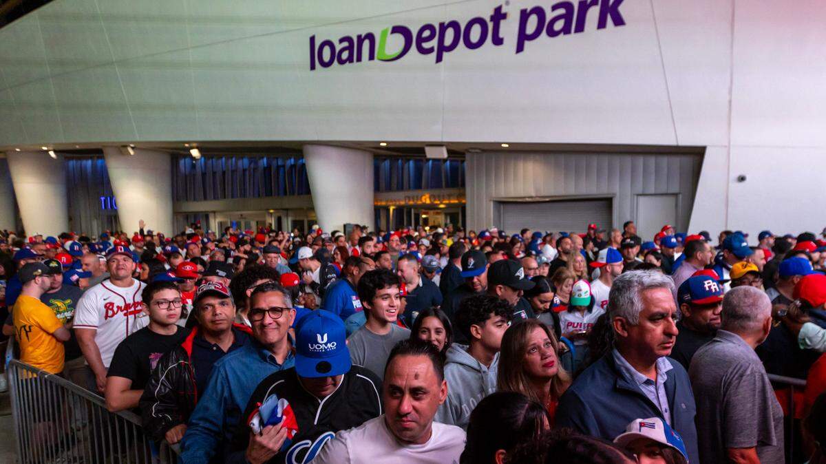 Baseball fans wait in lines to enter the bal park before he first inning of a Caribbean Series baseball game between Puerto Rico and Dominican Republic at loanDepot park in Miami, Florida, on Saturday, February 3, 2024.