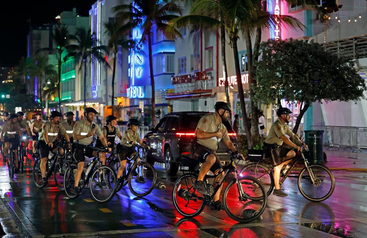 A downpour dampens spring break party as a Miami-Dade police bicycle unit patrols along Ocean Drive on Miami Beach, Florida on Saturday, March 16, 2024.