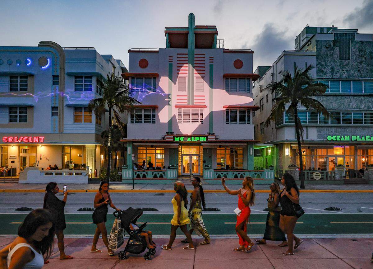 A U.S. Air Force jet is projected on the facade of Art Deco Hotels along Ocean Drive as attendees celebrate during Memorial Day Weekend at the Hyundai Air & Sea Show in Miami Beach, Florida, on Saturday, May 23, 2026.