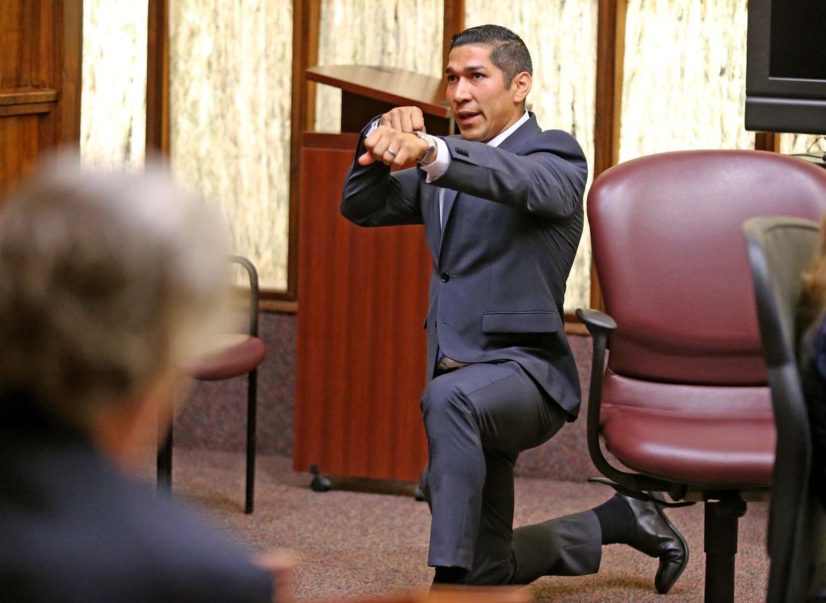 North Miami police officer Jonathon Aledda shows his position when he fired his weapon as he testifies at his second trial in Miami on Monday, June 17, 2019. Aledda is accused of attempted manslaughter for shooting at an autistic man holding a silver toy truck, instead hitting an unarmed caretaker. Aledda’s first trial in March ended in a mistrial.