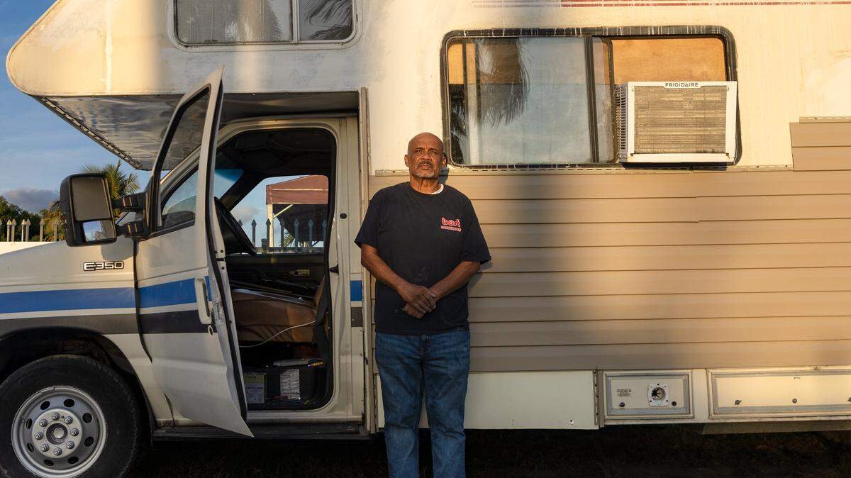 Angel Rogelio Diaz Franco, who was evicted from his home of 19 years in October, has ALS and is unable to work. With no money to find a new place to live, he stands outside the camper van in which he now lives on Sunday, Dec. 21, 2025, in Miami.