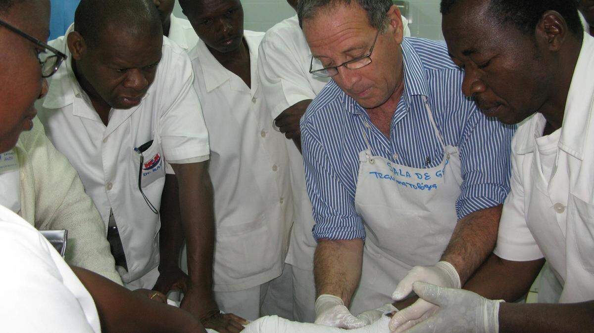 Dr. Elhanan Bar-On works with medical personnel tending to a child.