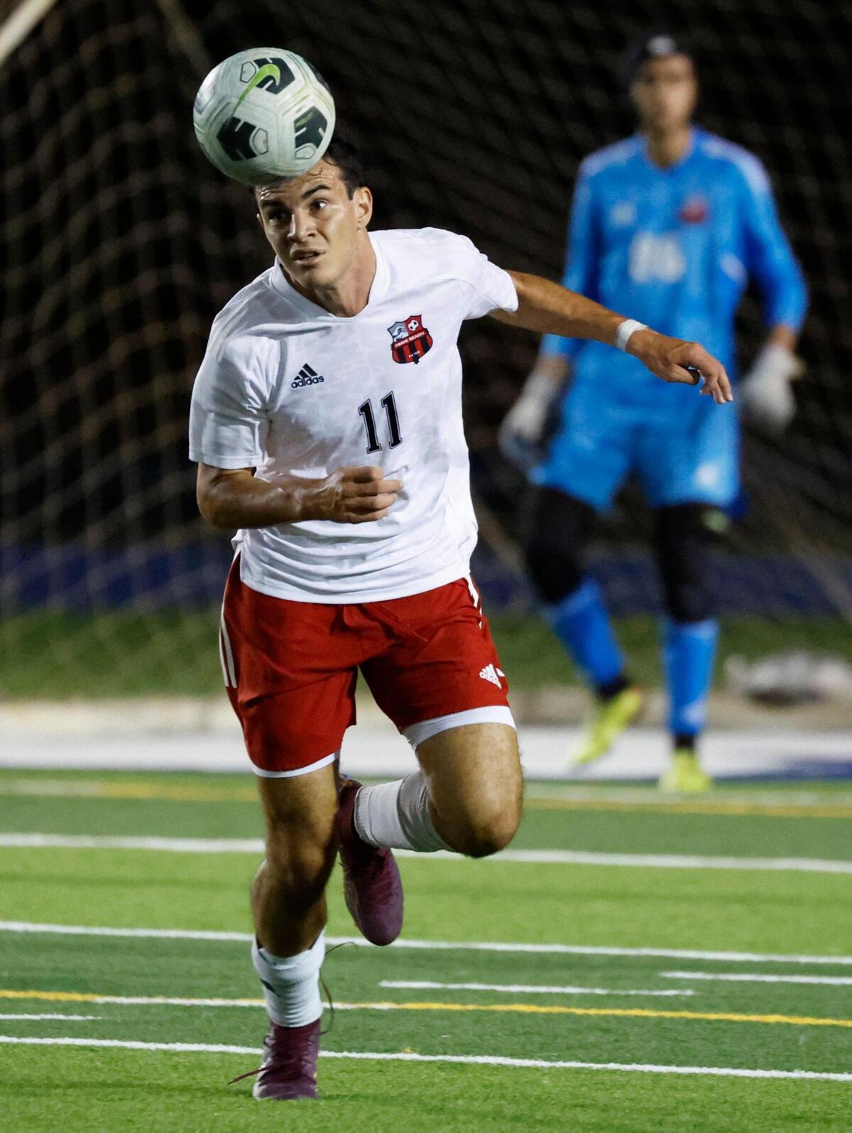 Miami Beach Senior High’s Tommaso Polidori (11) goes for a header during the game against Columbus High School in the GMAC soccer championship at Traz Powell Stadium in Miami on Friday, January 13, 2023.