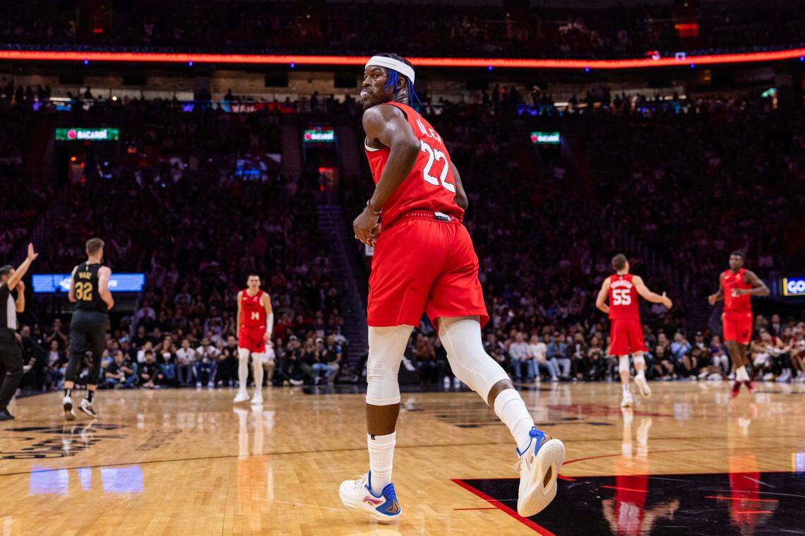 Miami Heat forward Jimmy Butler (22) looks back after dunking the ball over Cleveland Cavaliers center Jarrett Allen (31) during the second half of an NBA game at Kaseya Center on Dec. 8, 2024, in Miami.