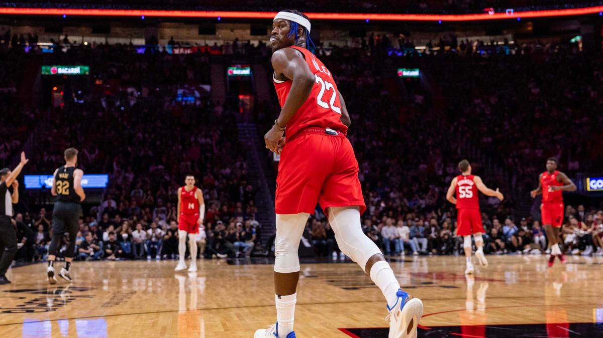 Miami Heat forward Jimmy Butler (22) looks back after dunking the ball over Cleveland Cavaliers center Jarrett Allen (31) during the second half of an NBA game at Kaseya Center on Dec. 8, 2024, in Miami.