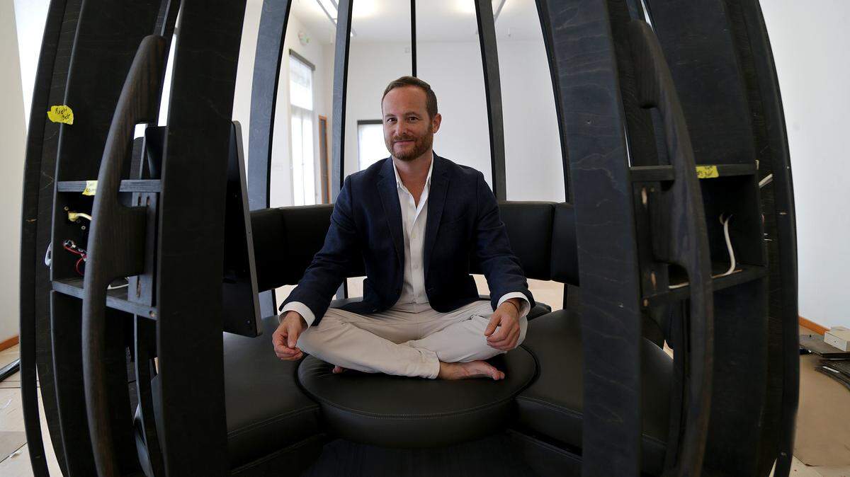 Jonathan Marcoschamer, founder and CEO of OpenSeed, poses inside a prototype in the assembly process of an OpenSeed meditation pod. Inside, a user can practice meditation and mindfulness.
