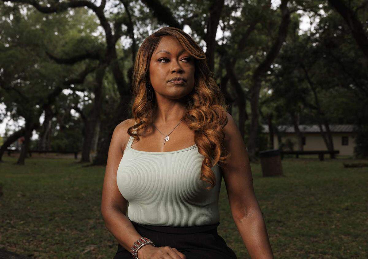 Cindy Doucet, otherwise known as SupaCindy, poses while reflecting on her story of abuse, and how she got away from her abuser on Wednesday, May 13, 2026, at Enchanted Forest Elaine Gordon Park in North Miami, Fla.