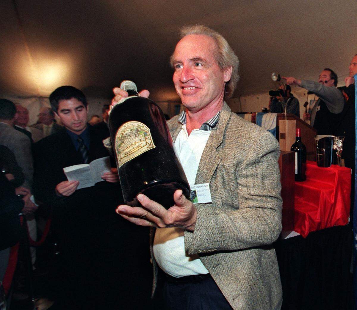In 1999, William Hebrank, senior wine consultant of Transatlantic Wine & Spirits and lLecturer at Florida International University, holds a bottle of 1982 Cabernet Sauvigon that was purchased for $1,500 during the Florida Extravaganza live auction.