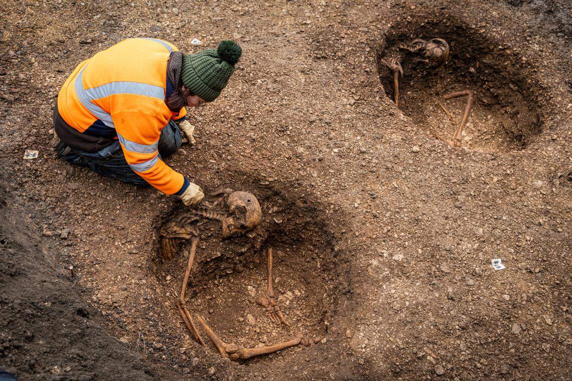 The graves were arranged in a line and evenly spaced.