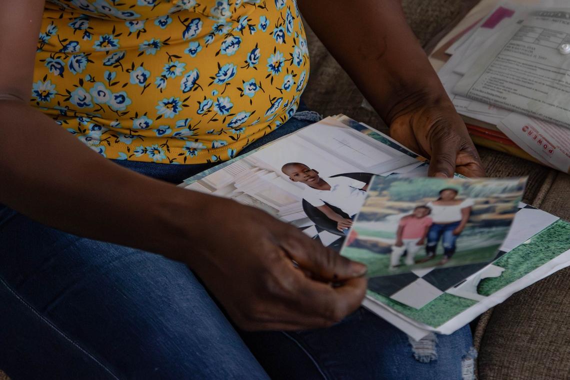 Figenie Dugard, mother of Ryan Amichette, 8, looks through family photos taken in May on Thursday, June 6, 2024 , in Fort Lauderdale, Fla. Ryan drowned in a neighbor’s pool on Monday.