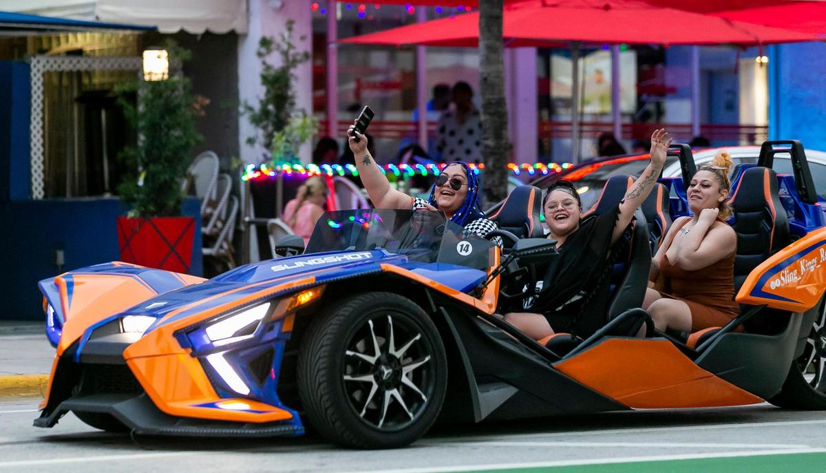 People drive down Ocean Drive in Miami Beach on Friday, Feb. 25, 2022.