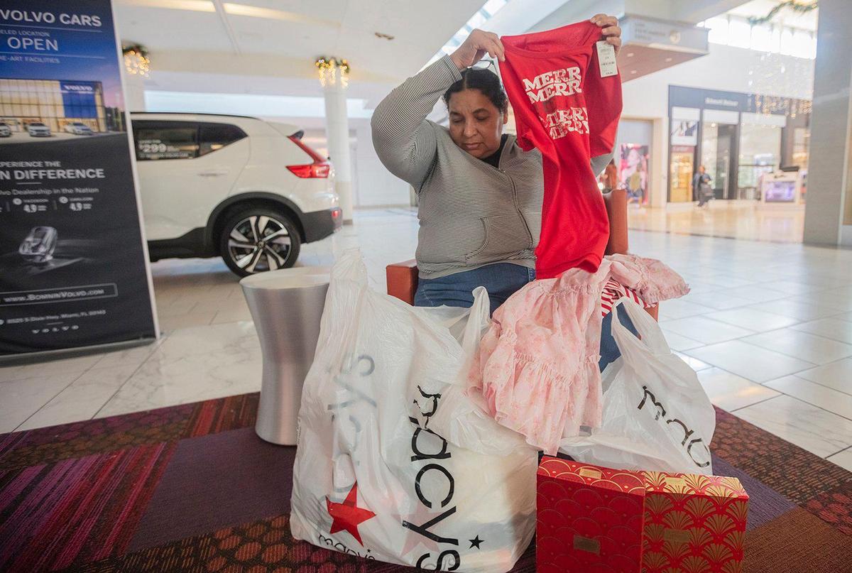 Macy’s makes merry as Aracely Guadamus gets gifts for her two granddaughters and her son during Black Friday at Dadeland Mall in Miami on Friday, Nov. 29, 2024. On Jan. 10, 2025, Macy’s announced it was to close 66 more stores but Dadeland’s is not one of them.