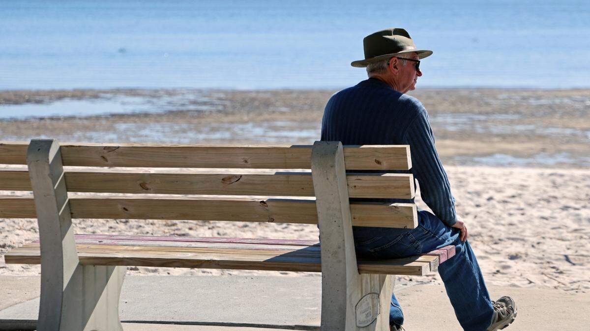 Johnny McDonald, who was visiting Florida from his home in Tennessee, sits on a park bench facing the open Gulf on Jan. 14 in Cedar Key, Fla. He doesn’t think the Gulf of Mexico should be renamed. “It’s not gonna help us,” he said.