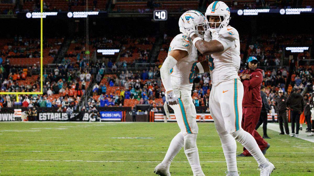 Miami Dolphins tight end Jonnu Smith (9) celebrates his touchdown with wide receiver River Cracraft (85) during the second half of a football game on Sunday, Dec. 29, 2024, at Huntington Bank Field in Cleveland, Ohio.