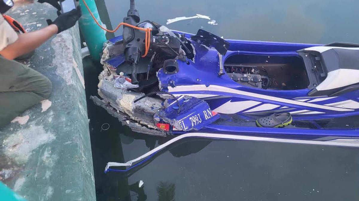 A personal watercraft floats against a seawall in the Middle Florida Keys city of Marathon Tuesday, Aug. 13, 2024. A father and son died in the crash, according to the Monroe County Sheriff’s Office.